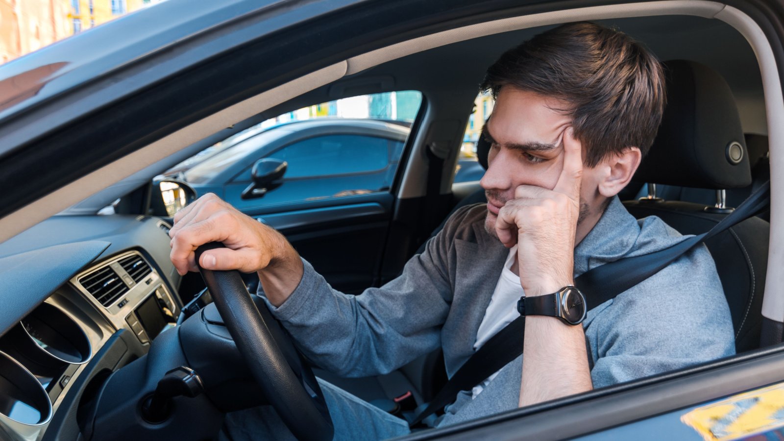 male in car tired traffic congestion