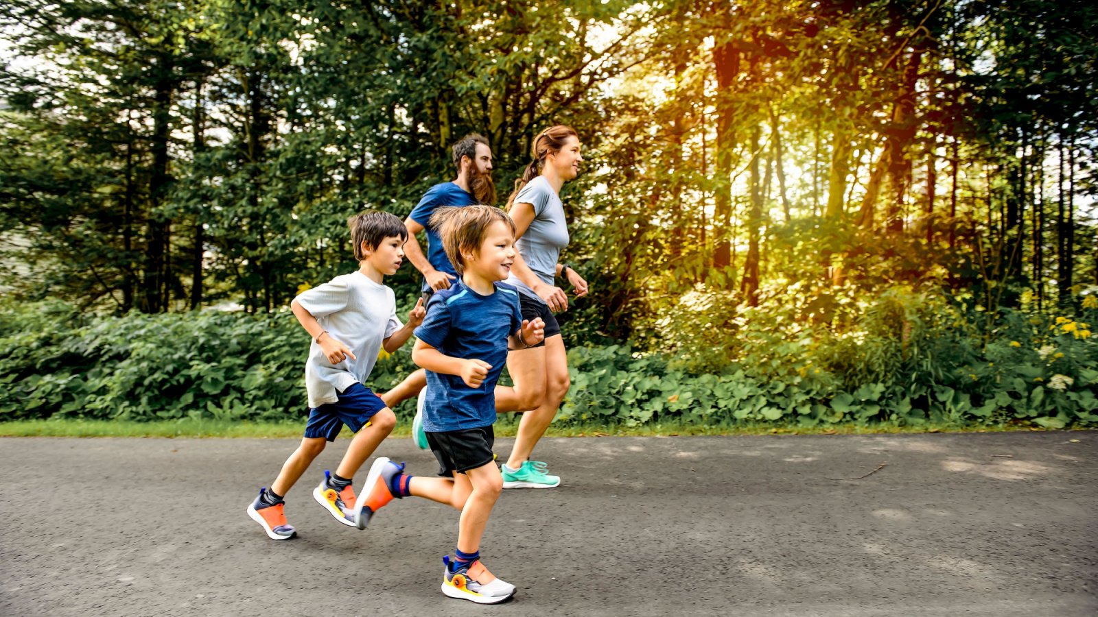 A Family Exercising and Jogging together at an outdoor Park Fitness Kids Lopolo Shutterstock