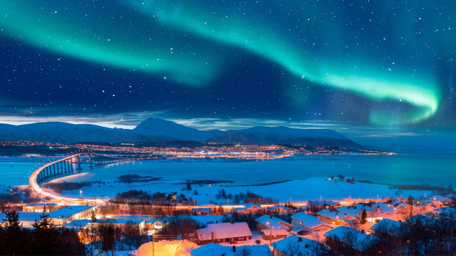 Aurora borealis or Northern lights in the sky over Tromso with Sandnessundet Bridge Tromso Norway muratart Shutterstock Aurora borealis or Northern lights in the sky over Tromso with Sandnessundet Bridge Tromso Norway muratart Shutterstock