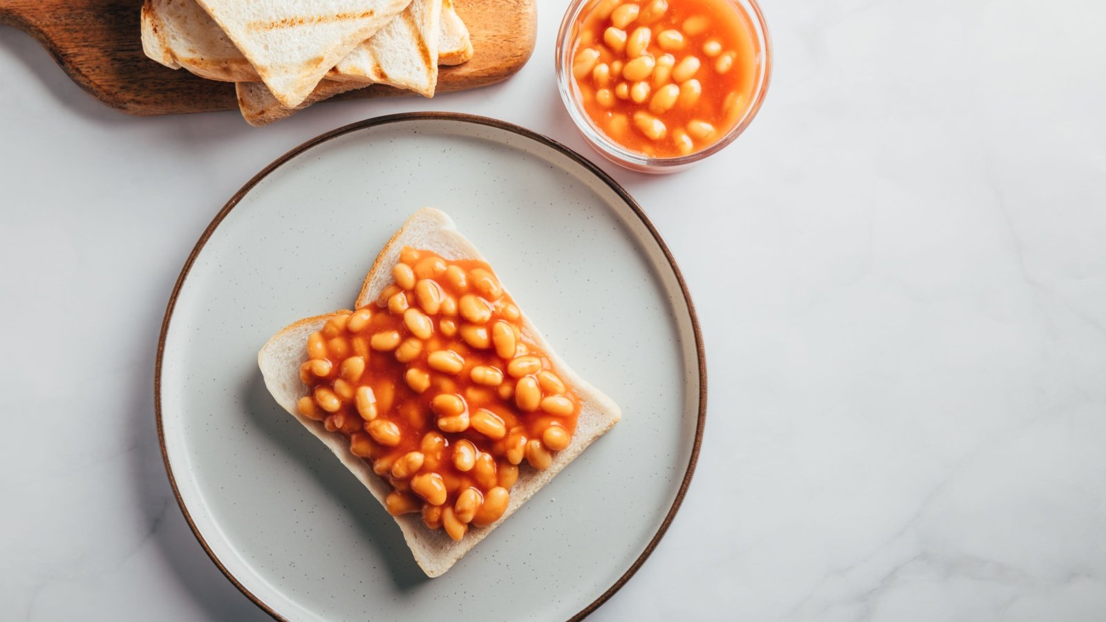 Baked Beans in Tomato Sauce on Slice of Toasted Bread traditional British breakfast Anna Mente Shutterstock