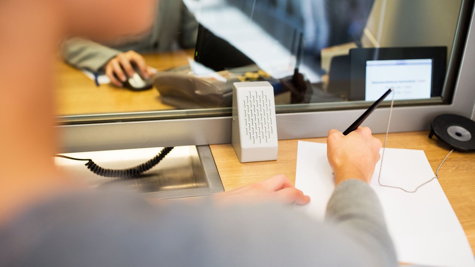 Bank customer and teller writing credit card debit card finance check money Ground Picture Shutterstock