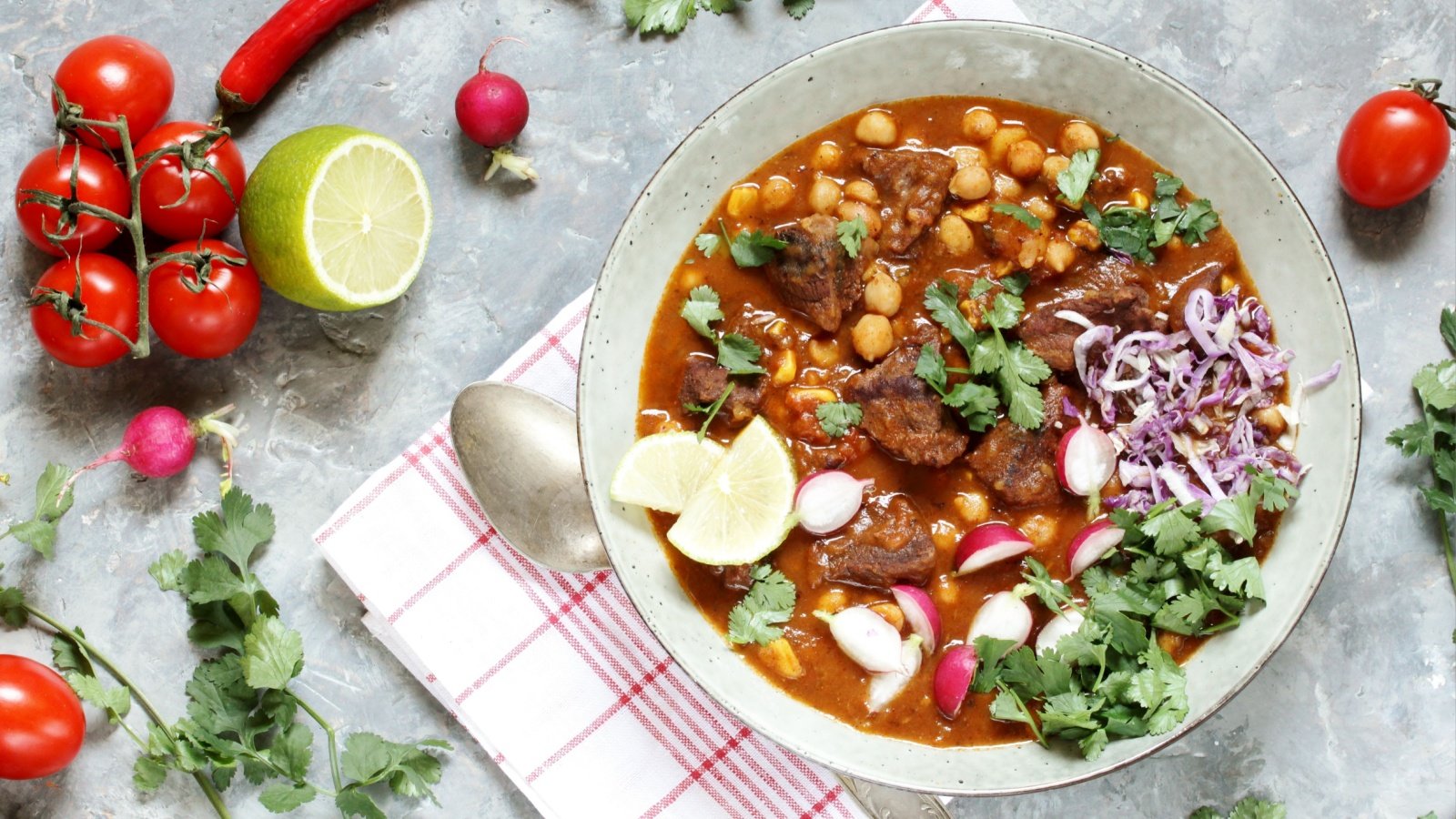 Beef Pozole with beef and chickpeas festive Mexican soup limes radishes cabbage hominy Lyudmila Mikhailovskaya Shutterstock