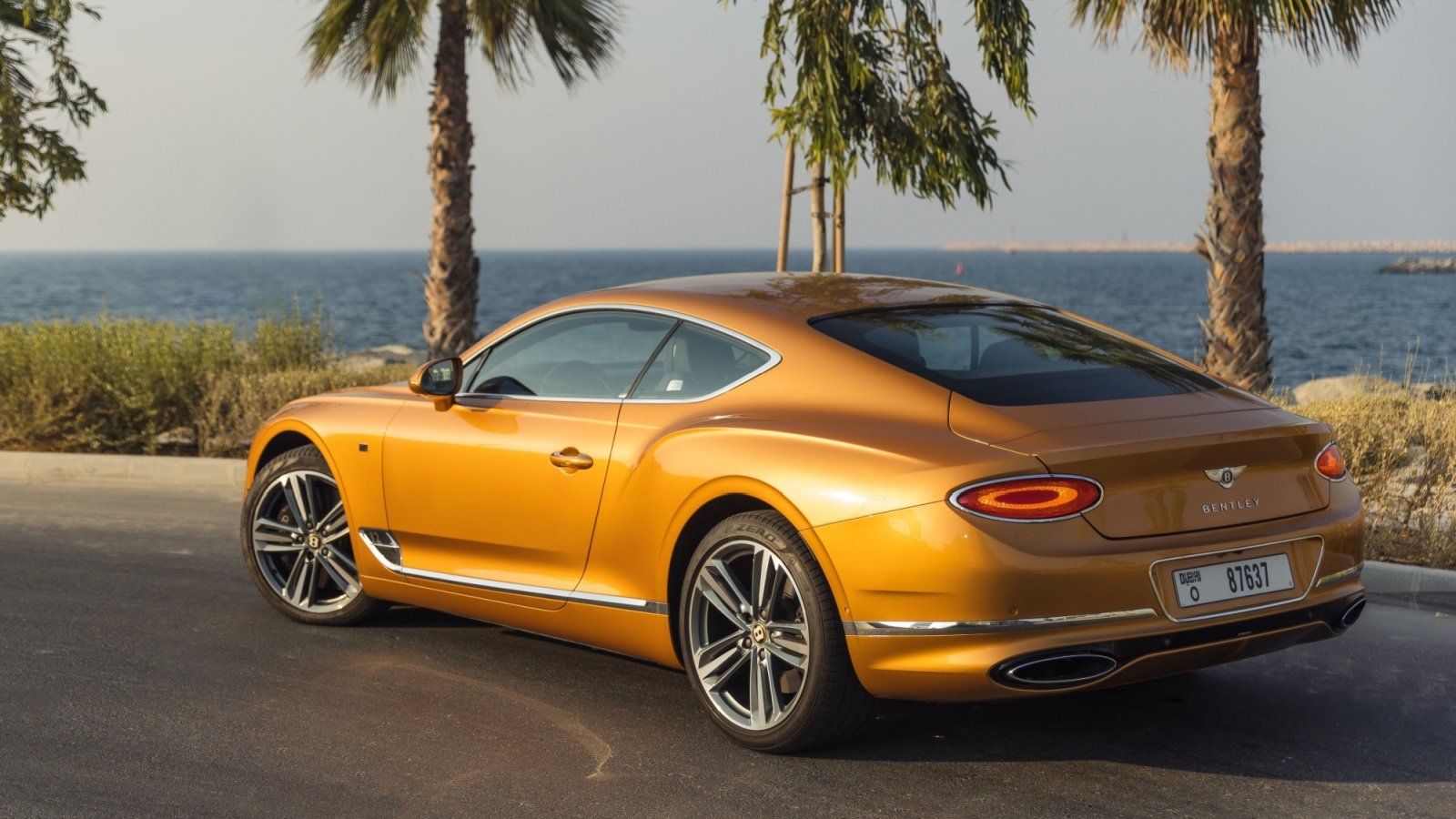 Bentley Continental GT Gold exterior, luxury car, carsguru Shutterstock