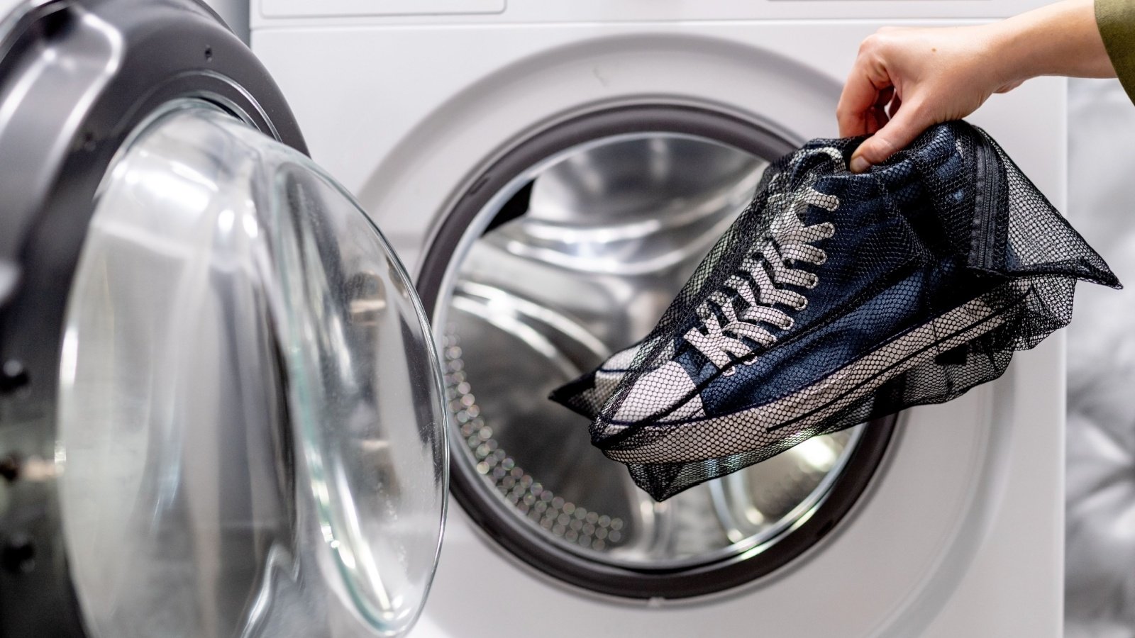 Blue sneakers in mesh bag washing machine laundry Damian Lugowski Shutterstock Blue sneakers in mesh bag washing machine laundry Damian Lugowski Shutterstock