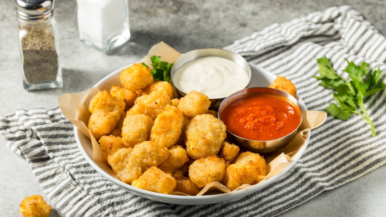 Bowl of Deep Fried Wisconsin cheese curds with dipping sauce Brent Hofacker Shutterstock