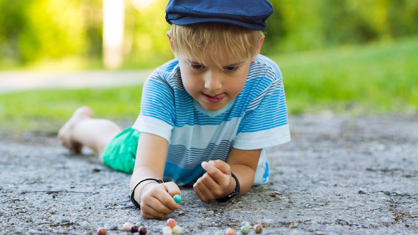 Boy child kid playing outside marbles game Stephanie F Clarke Shutterstock