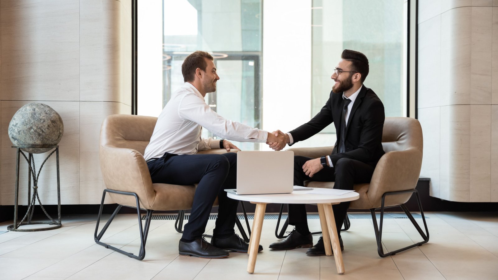 Business Male Investor Meeting Professional Deal Hand Shake fizkes Shutterstock