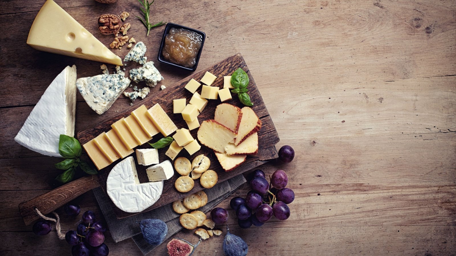 Cheese plate served with grapes, jam, figs, crackers and nuts charcuterie baibaz shutterstock