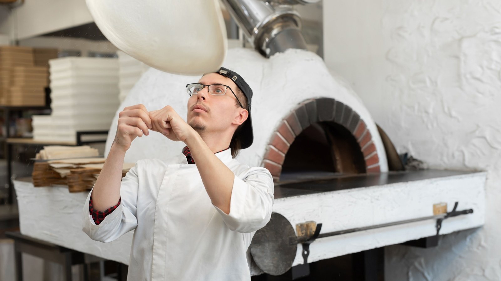 Chef makes the pizza dough toss spin restaurant oven Studio Peace Shutterstock Chef makes the pizza dough toss spin restaurant oven Studio Peace Shutterstock