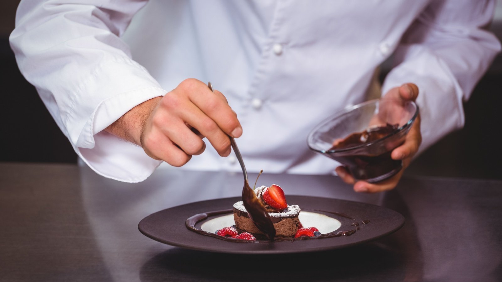 Chef plating sauce chocolate dessert baking cooking wavebreakmedia Shutterstock