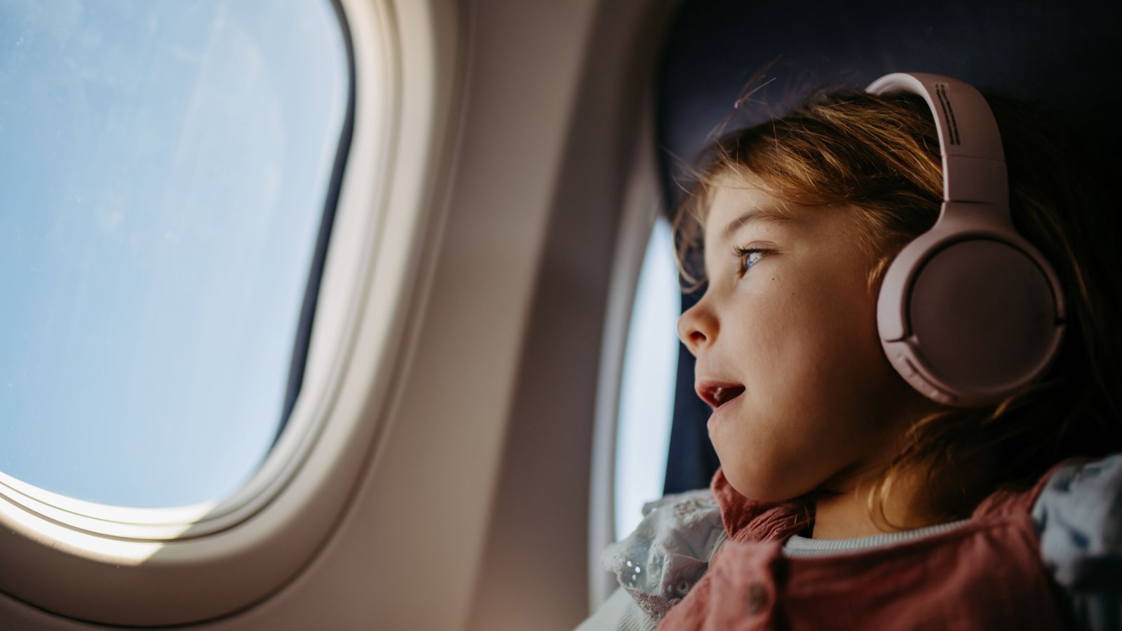 Child Woman girl kids airplane window travel parenting Halfpoint Shutterstock