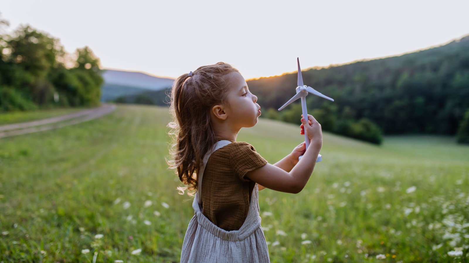 Climate change renerative renewable energy wind turbine solar child green Halfpoint Shutterstock