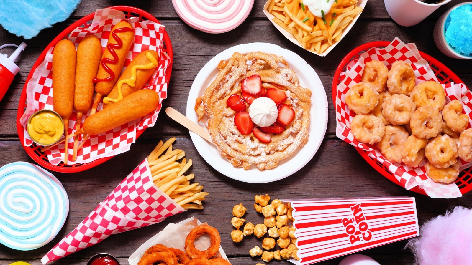 Corn dogs, funnel cake, cotton candy and snacks carnival food JeniFoto Shutterstock