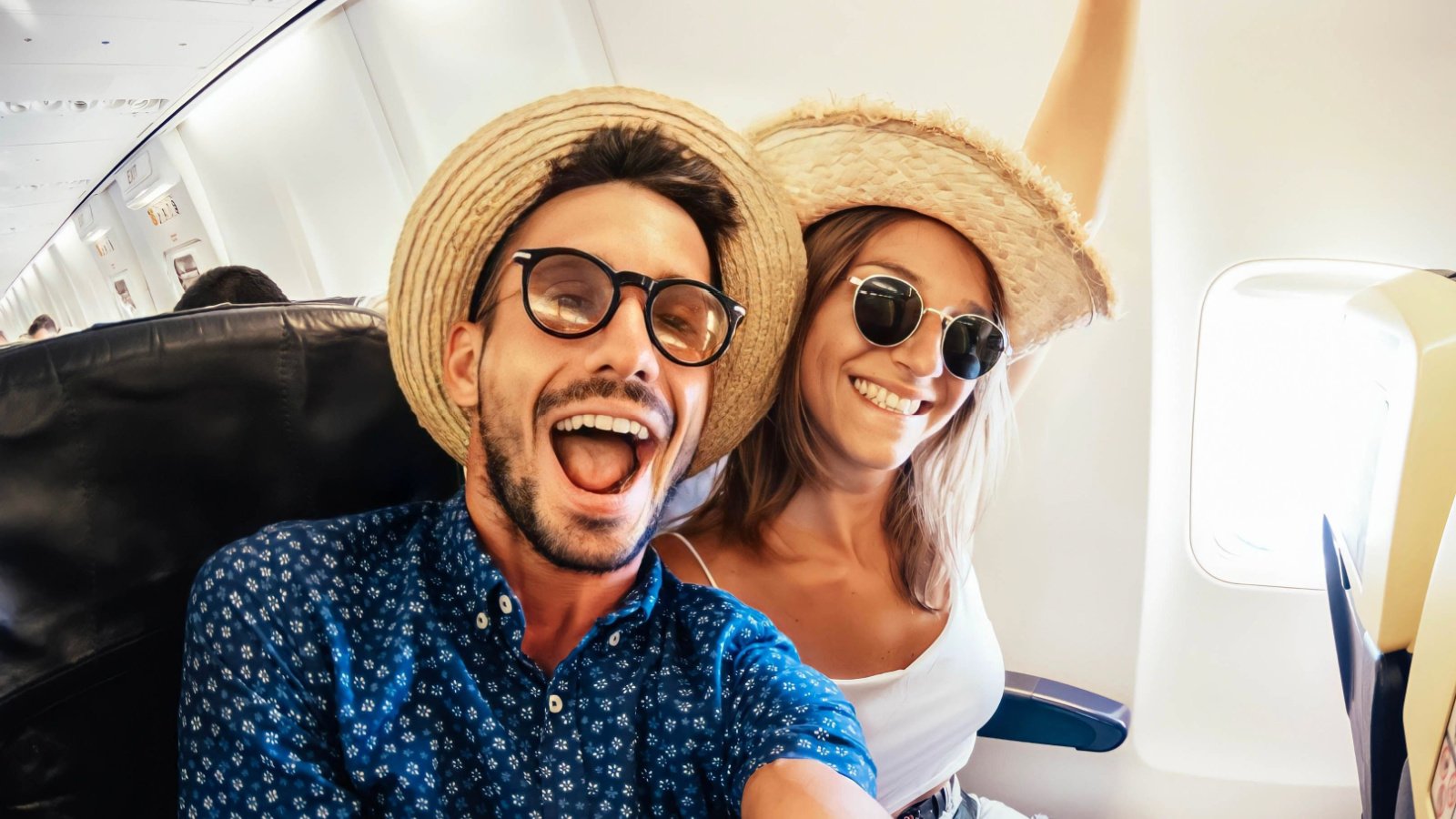 Couple Happy Travel honeymoon Airplane DavideAngelini Shutterstock