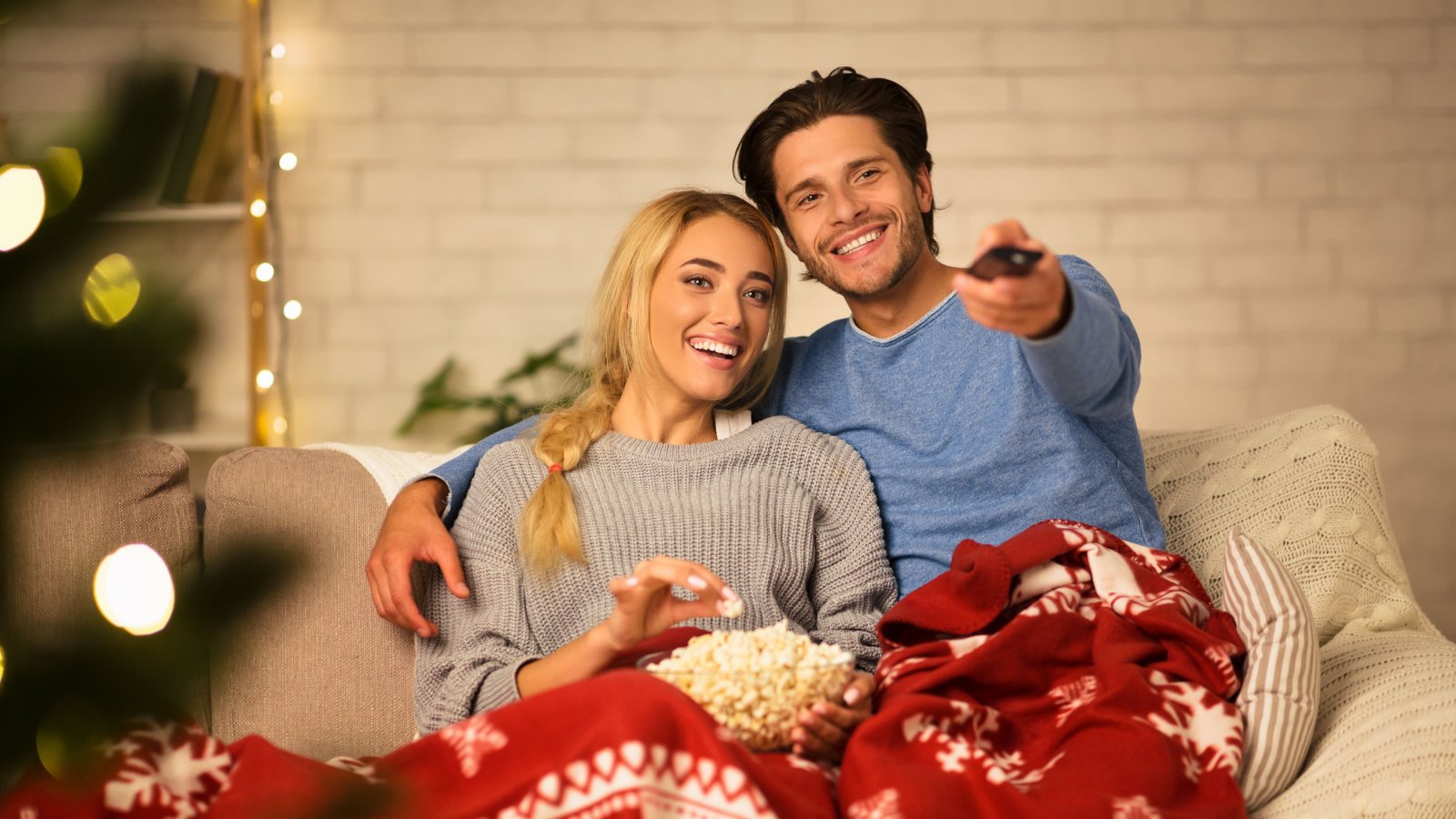 Couple Holiday Christmas Movie couch TV Prostock studio Shutterstock