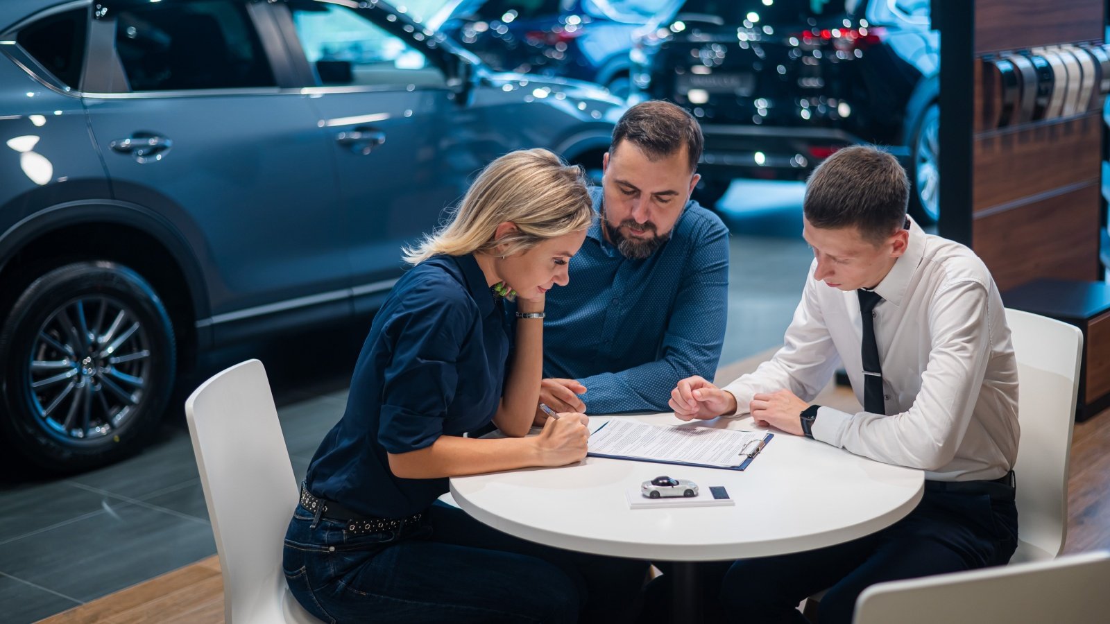 Couple buying a car at a dealership Reshetnikov art Shutterstock