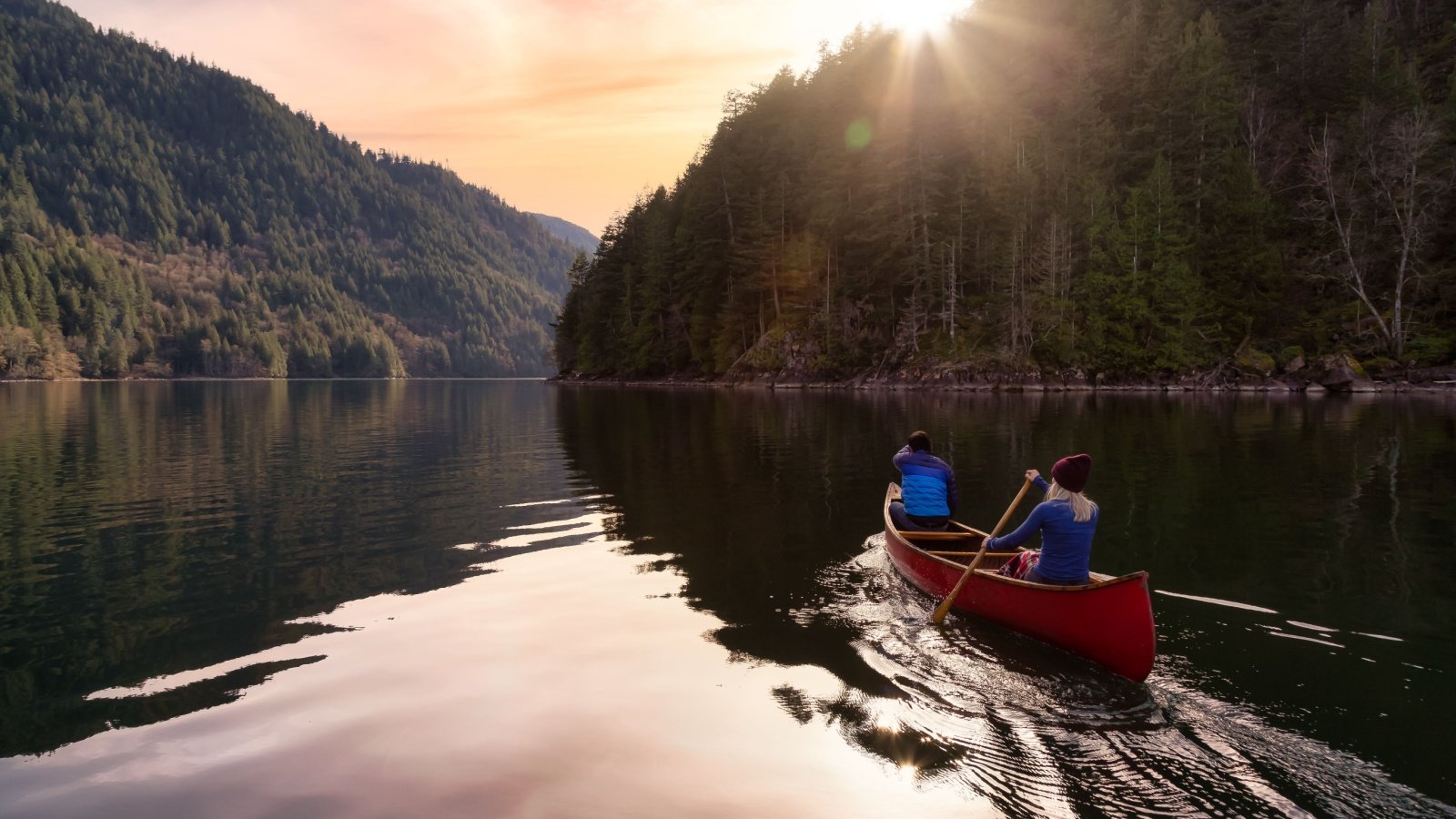 Couple canoeing in lake river mountain forest water sports outdoor exercise Harrison River Vancouver Canada EB Adventure Photography Shutterstock