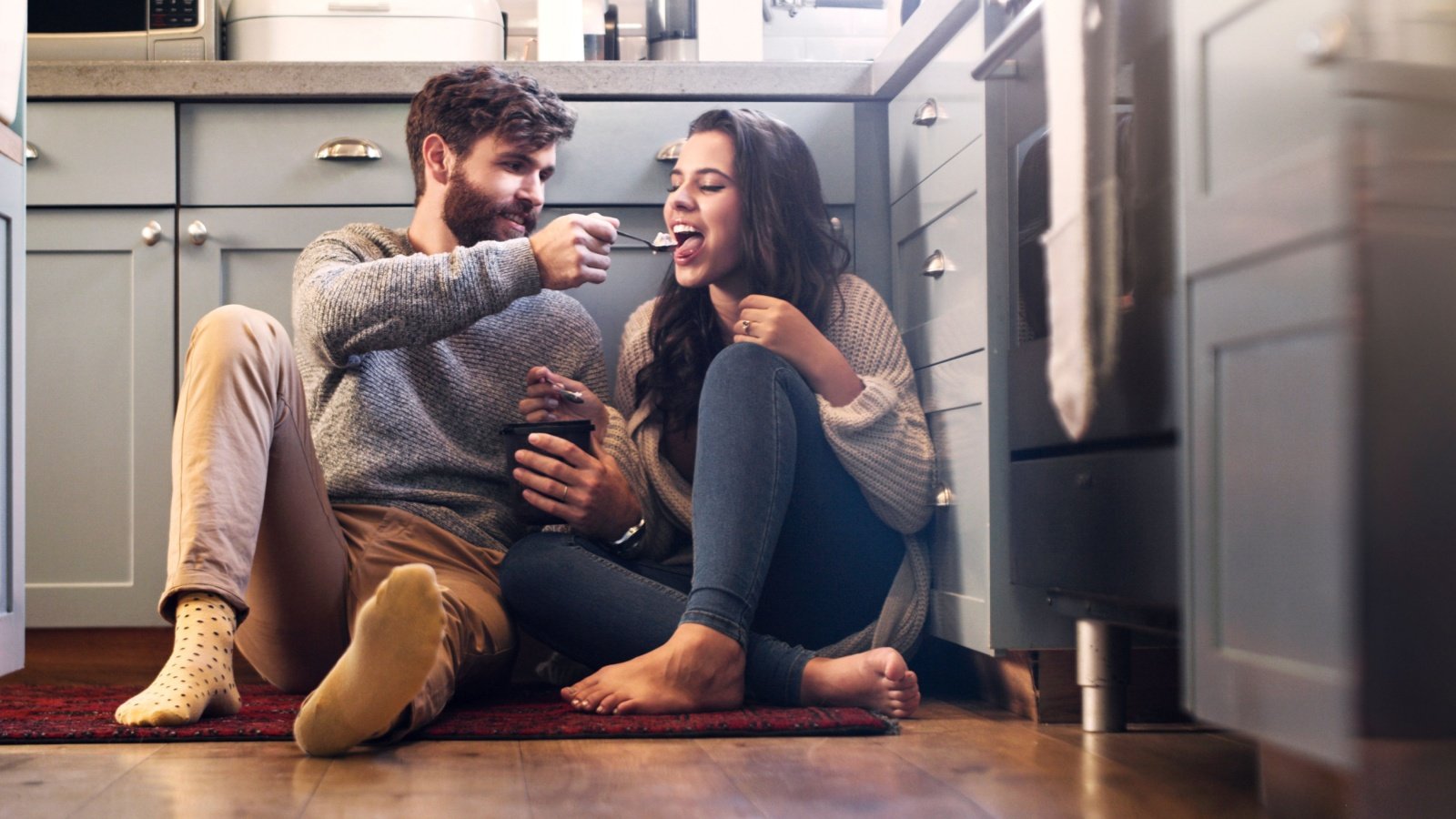 Couple on the kitchen floor eating ice cream PeopleImages.com Yuri A Shutterstock