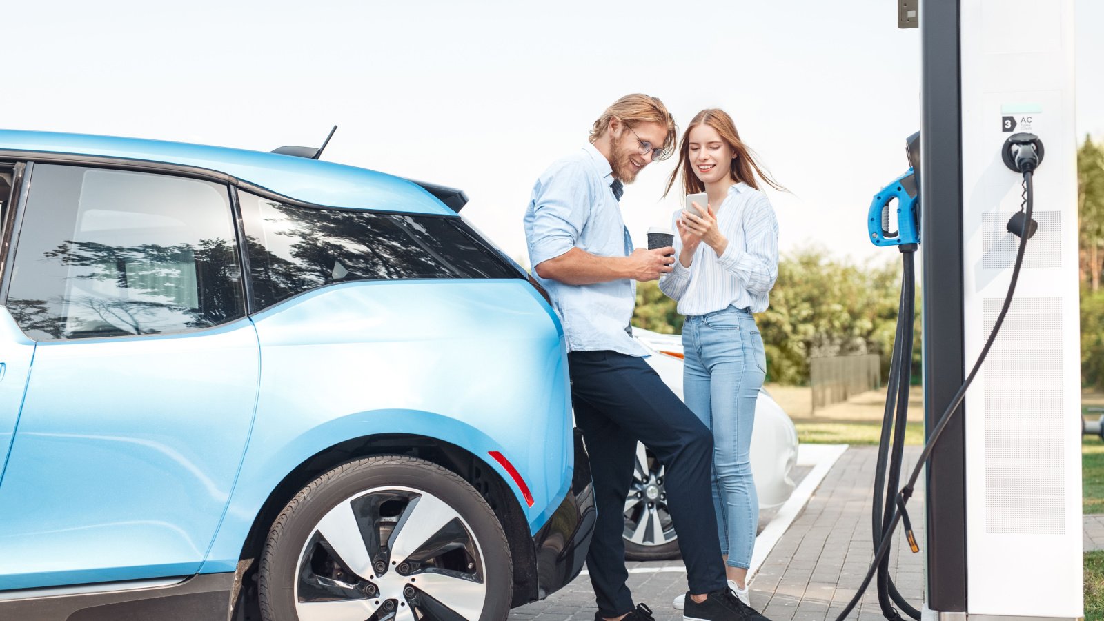 Couple travel charging station electric car vehicle Viktoriia Hnatiuk Shutterstock