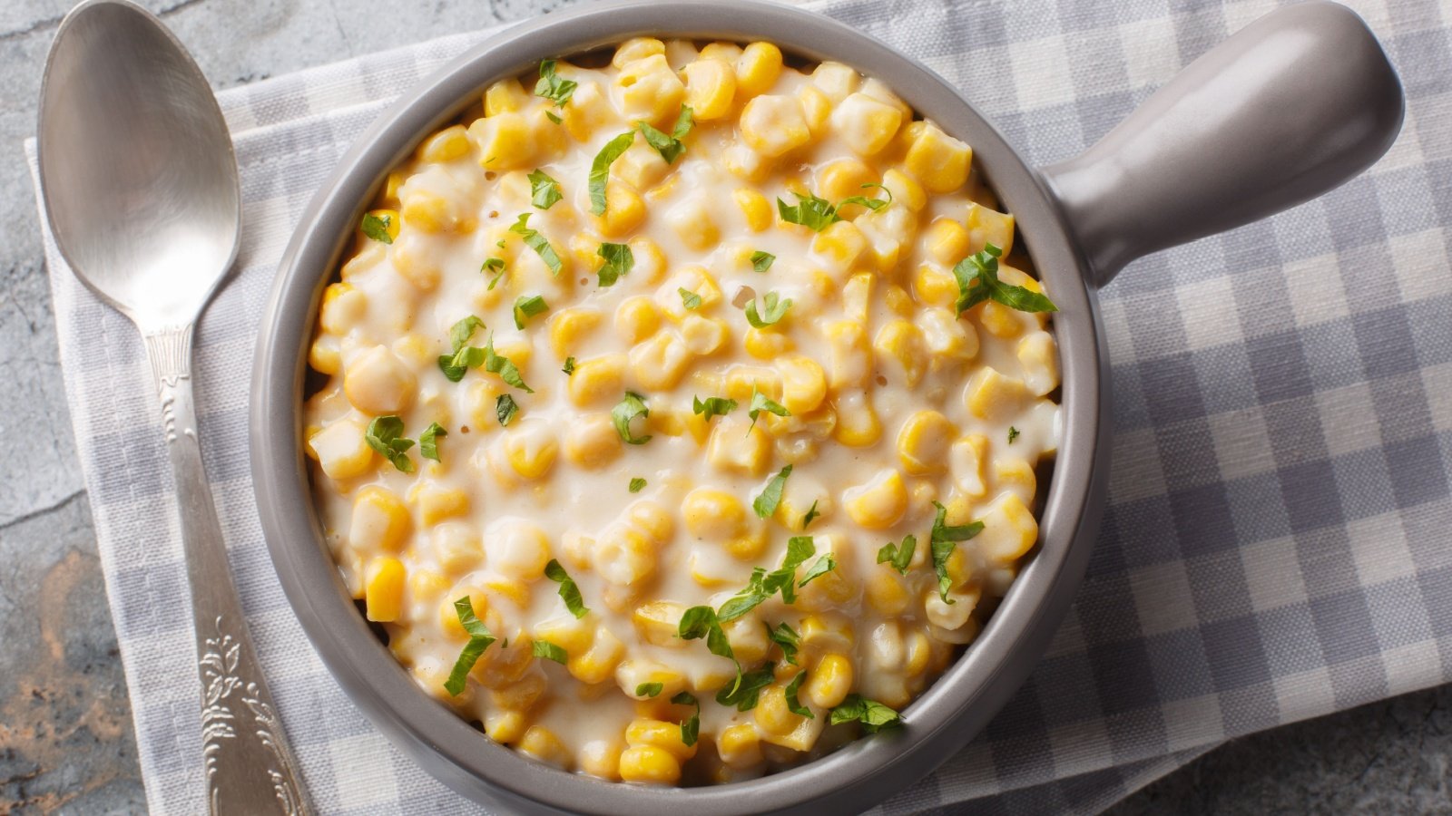 Creamed corn garnished with parsley bowl spoon AS Foodstudio Shutterstock Creamed corn garnished with parsley bowl spoon AS Foodstudio Shutterstock