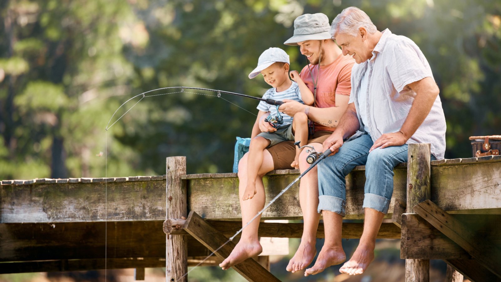 Dad, grandfather and teaching child fishing lake pond nature PeopleImages.com Yuri A Shutterstock