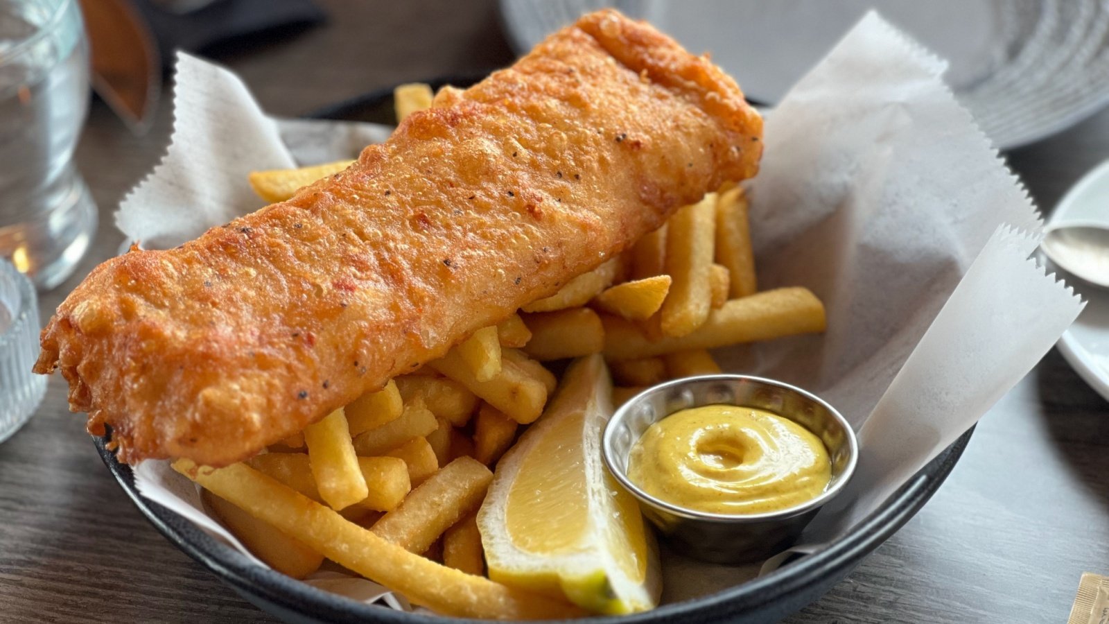 Deep fried cod fish and chips with a lemon slice and sauce tartare fivetonine Shutterstock