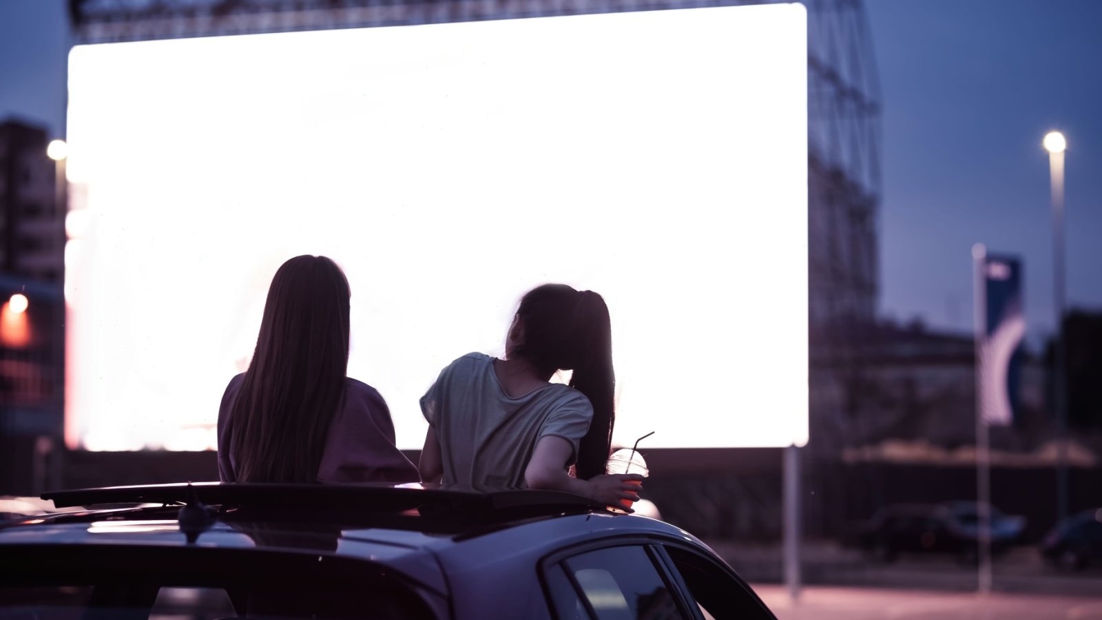 Drive in movie friends entertainment cinema outing car BAZA Production Shutterstock