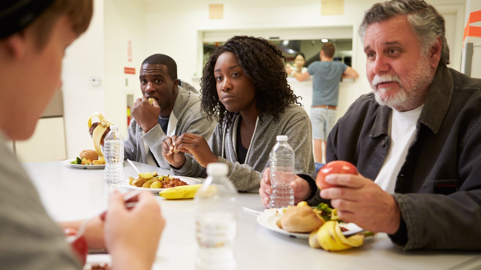 Eating Food In Homeless Shelter Monkey Business Images Shutterstock