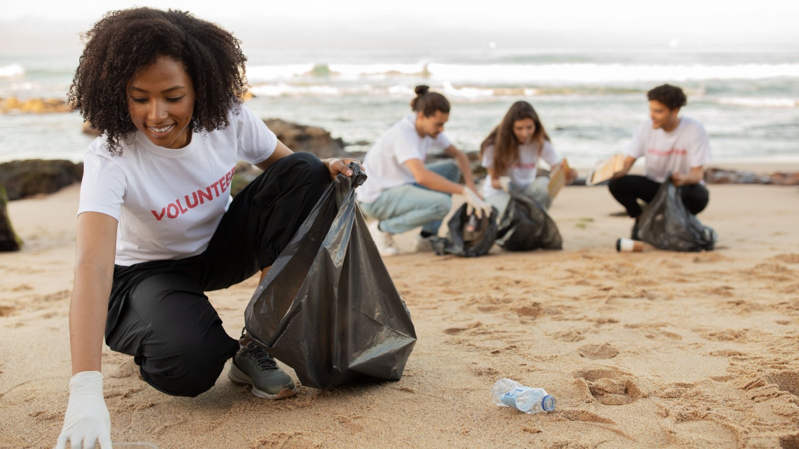 Eco, environment conservation, protecting planet volunteer beach Prostock studio Shutterstock