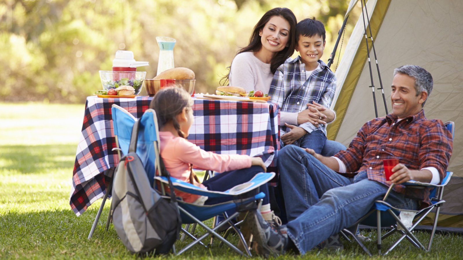 Family Enjoying Camping Holiday outdoors monkey business images shutterstock