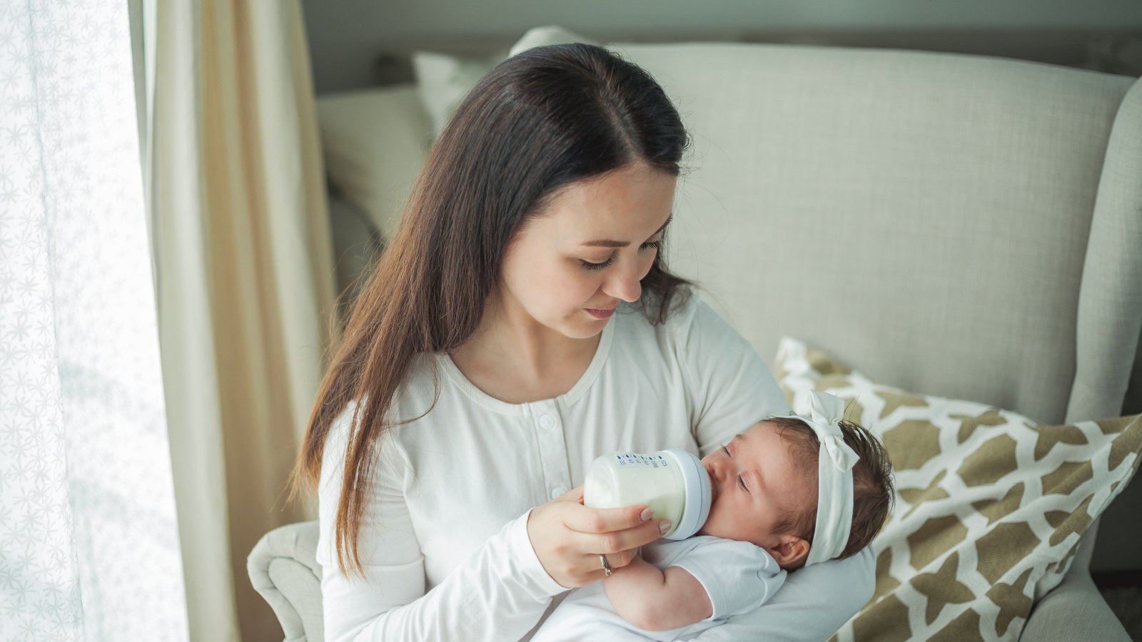 Female feeding baby with a bottle Krystyna89 Shutterstock