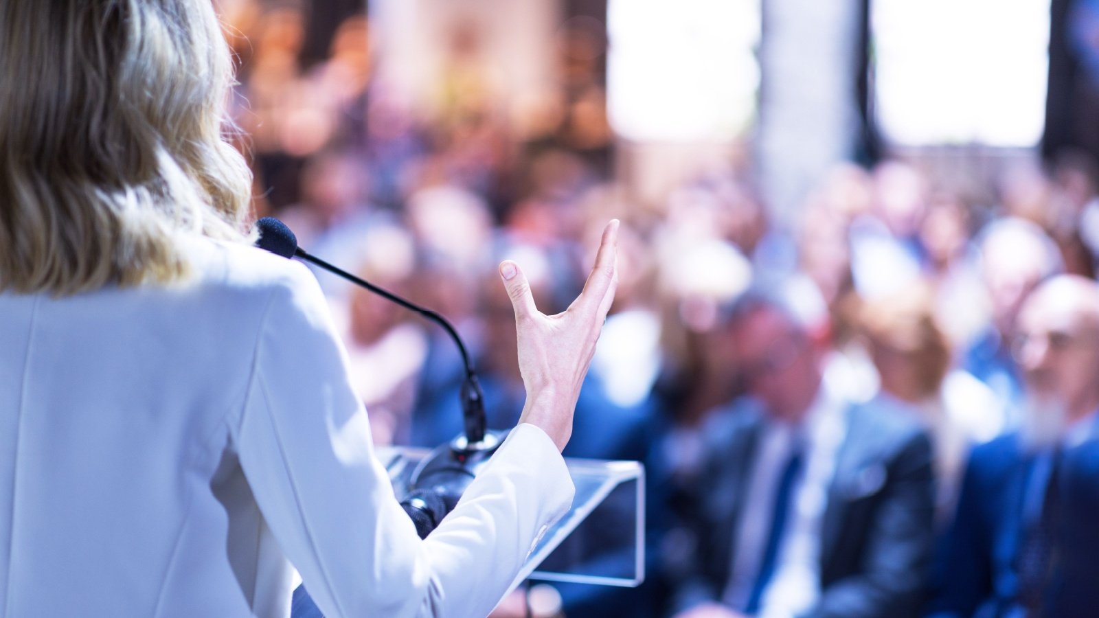 Female speaker at business conference corporate presentation workshop coaching training news conference company meeting public or political event Public speaking wellphoto Shutterstock