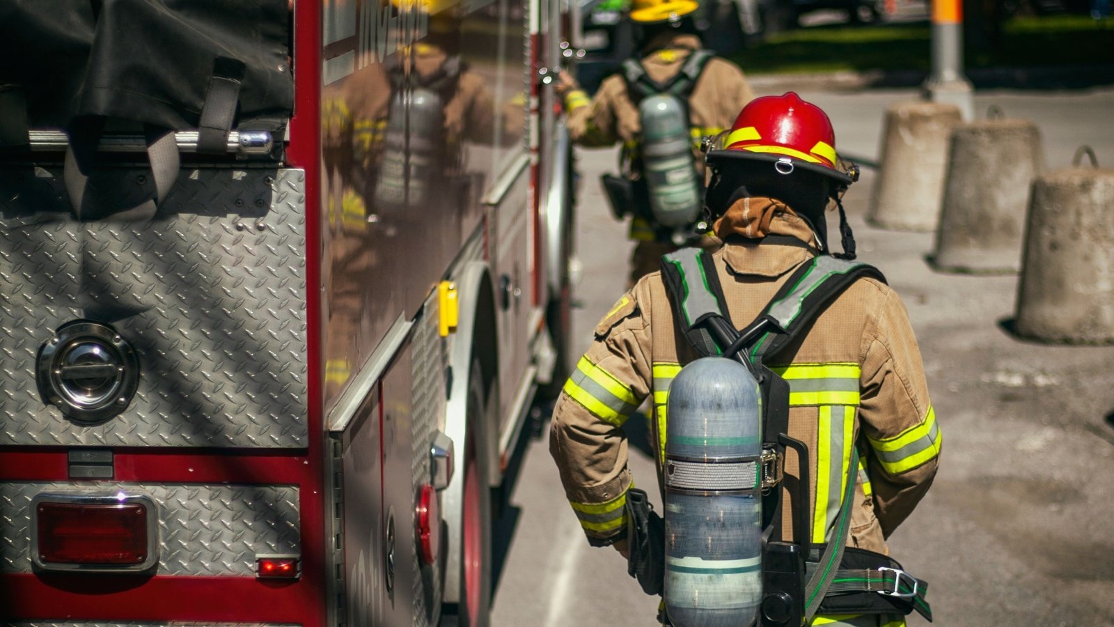 Firefighters walking to the fire truck emergency firetruck 911 Firefighter Montreal Shutterstock