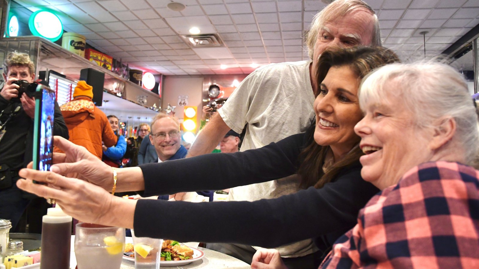 Former U.N. Ambassador Nikki Haley poses for a selfie with voters Andrew Cline Shutterstock