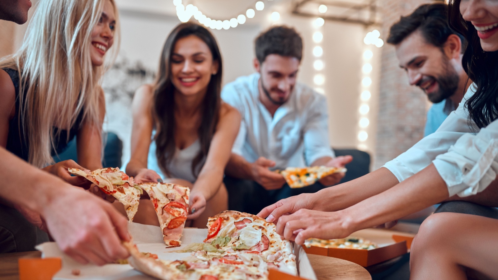 Friends Eating Pizza Celebrating 4 PM production Shutterstock