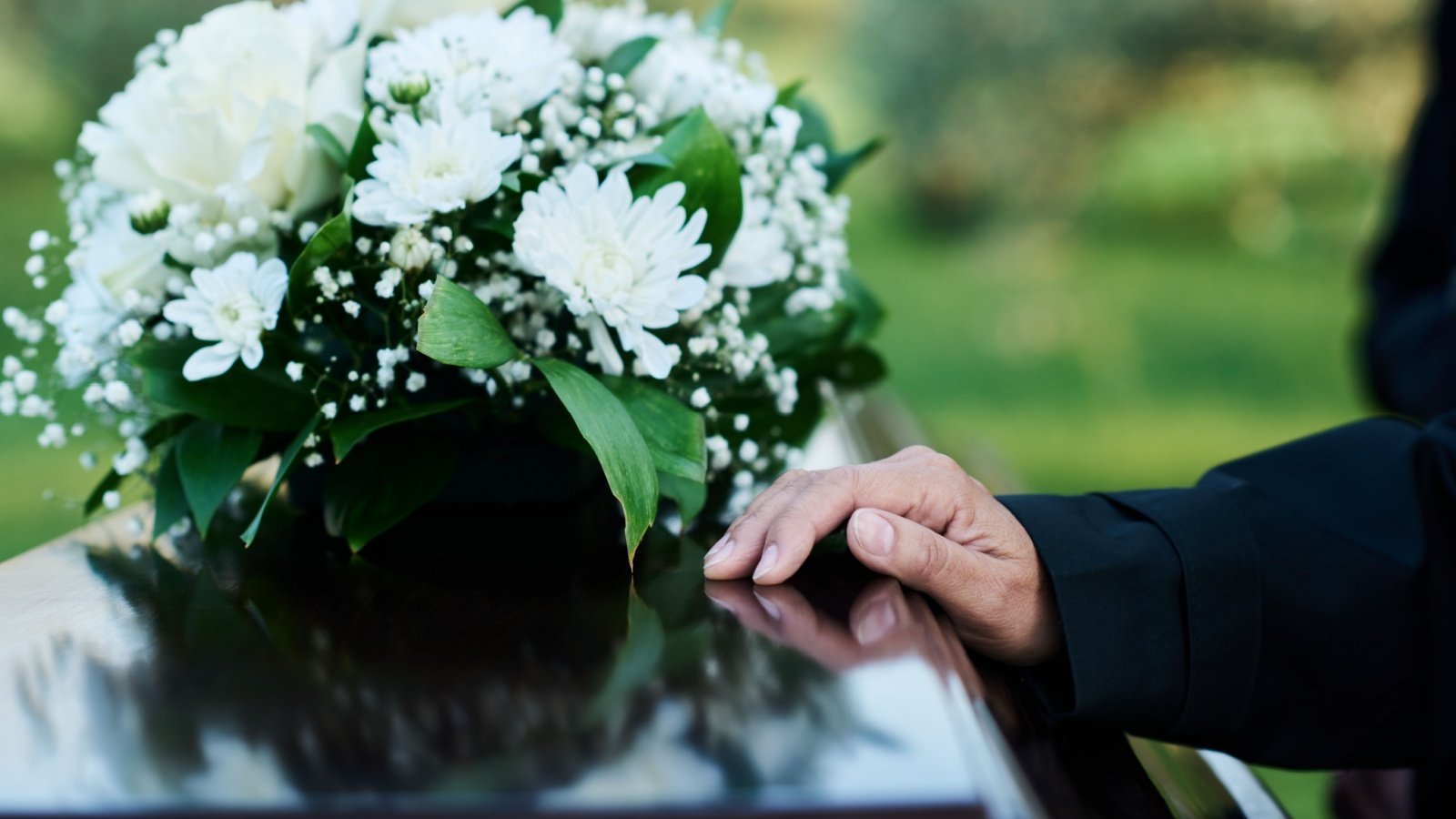 Funeral mourning flowers casket grief sorrow memorial service cemetery loss Pressmaster Shutterstock