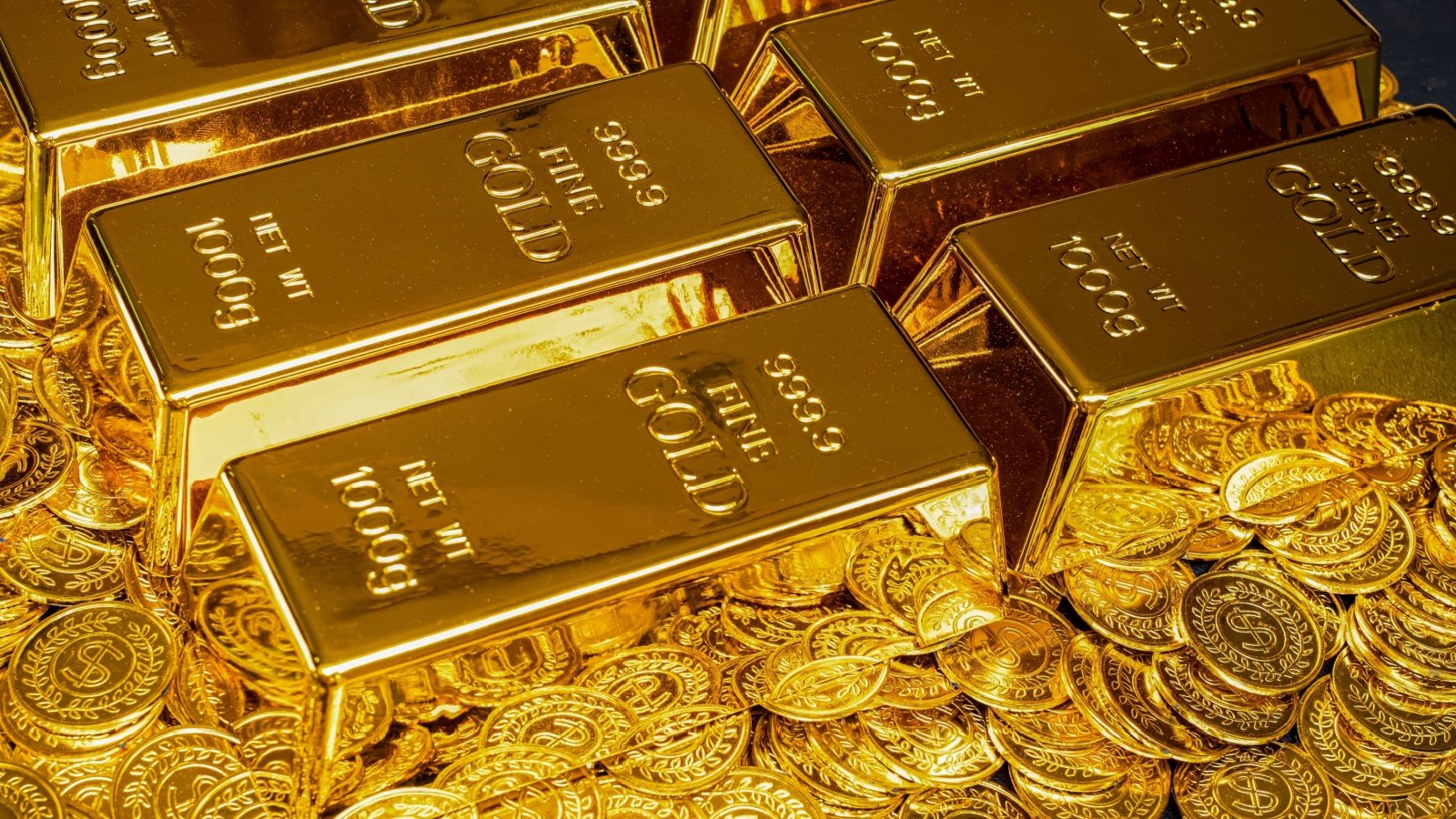 Gold bars and coins wealth treasure money Thichaa Shutterstock