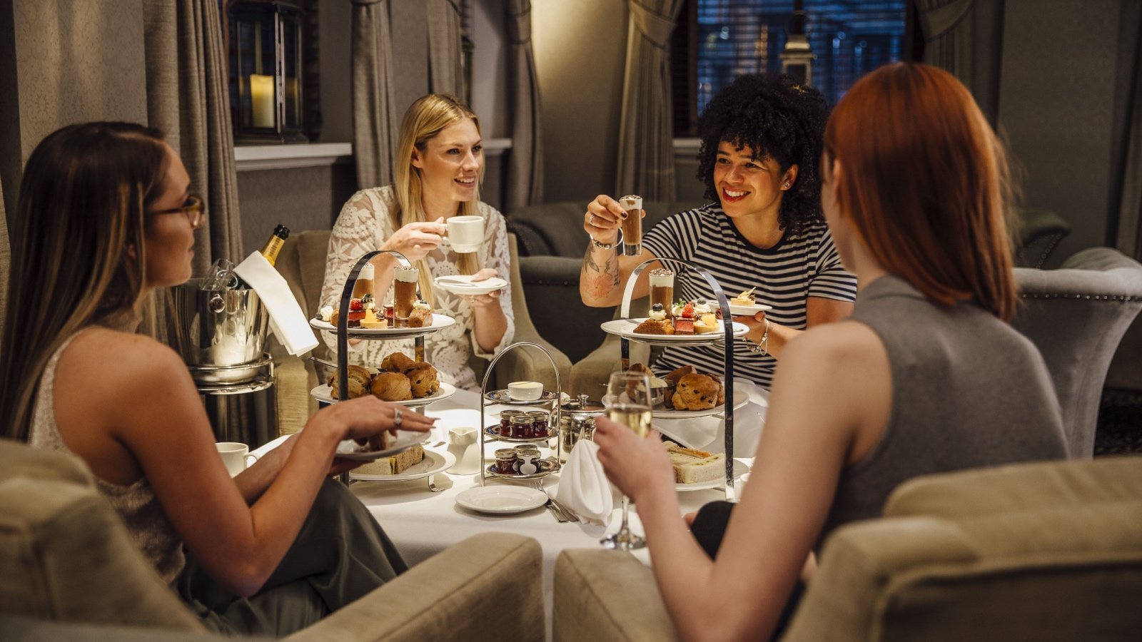 Group of women drinking tea and eating DGLimages Shutterstock