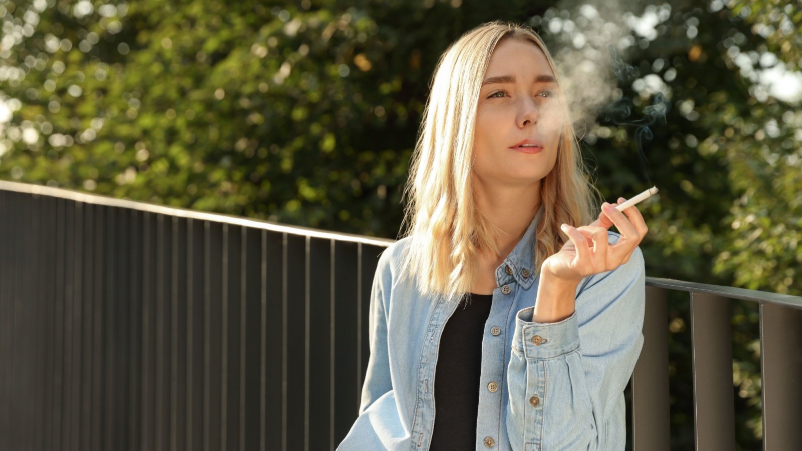 Hands holding cigarettes smoking smoke tobacco woman New Africa Shutterstock