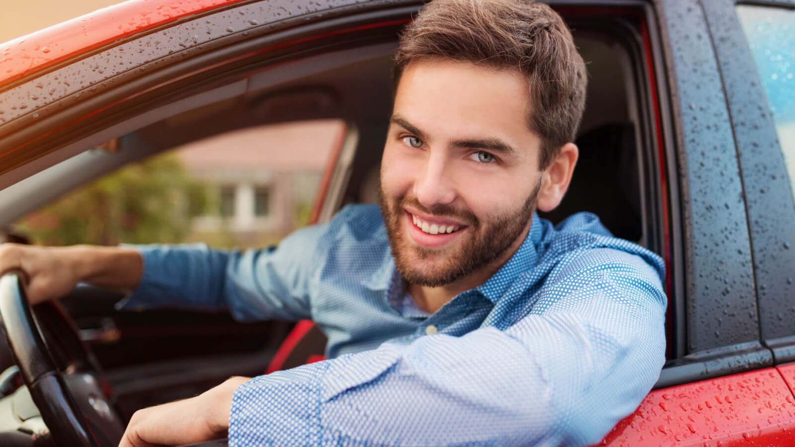 Handsome young male in a blue shirt driving a car ground picture shutterstock