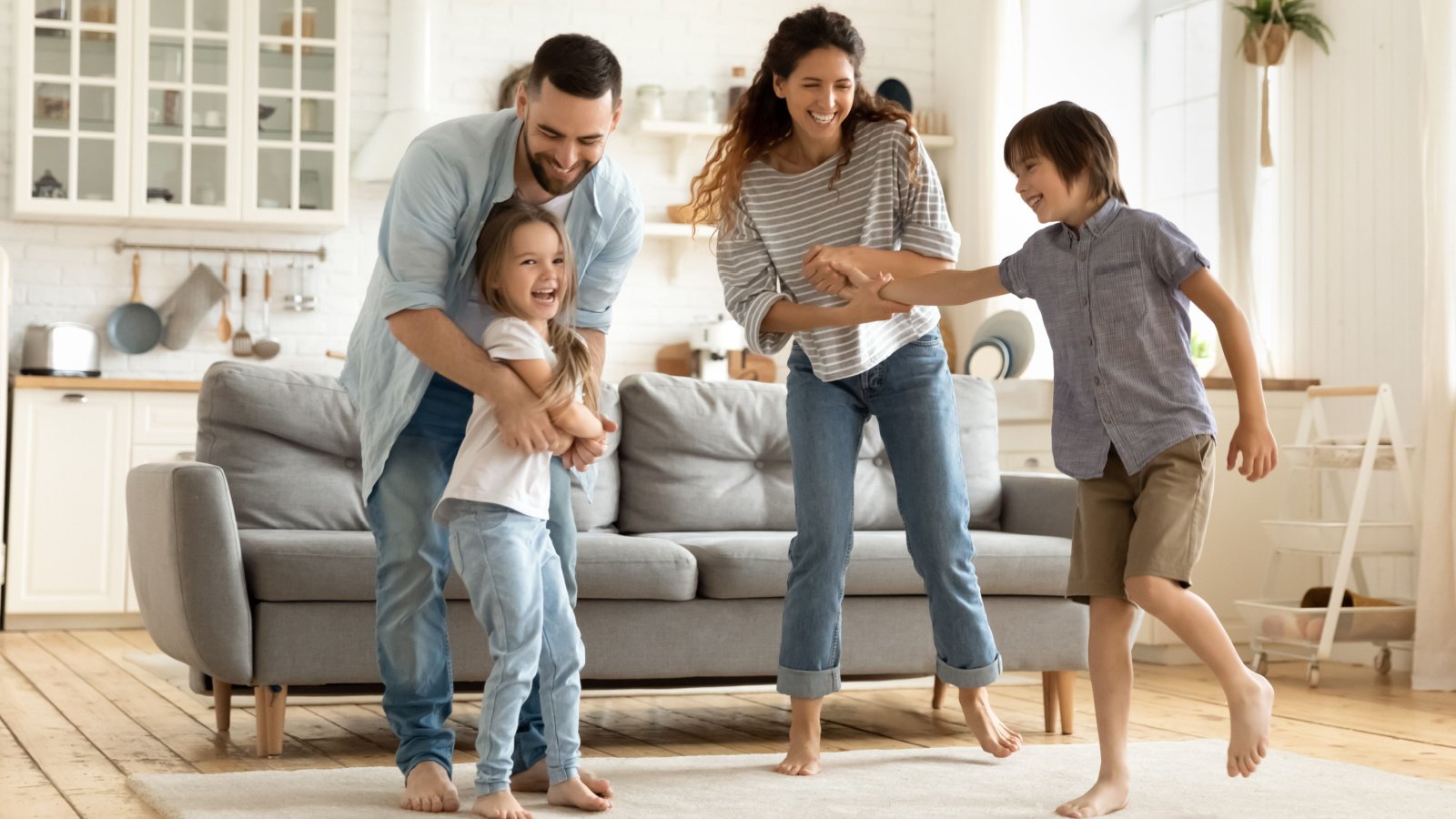 Happy family playing funny game having fun together in modern living room fizkes shutterstock