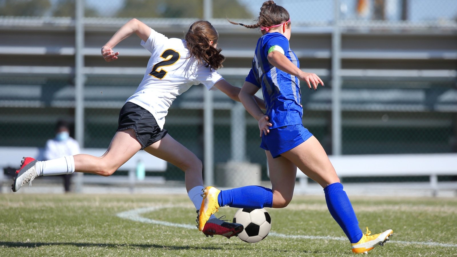 High school teen girls playing soccer game sports athletes JustPixs Shutterstock