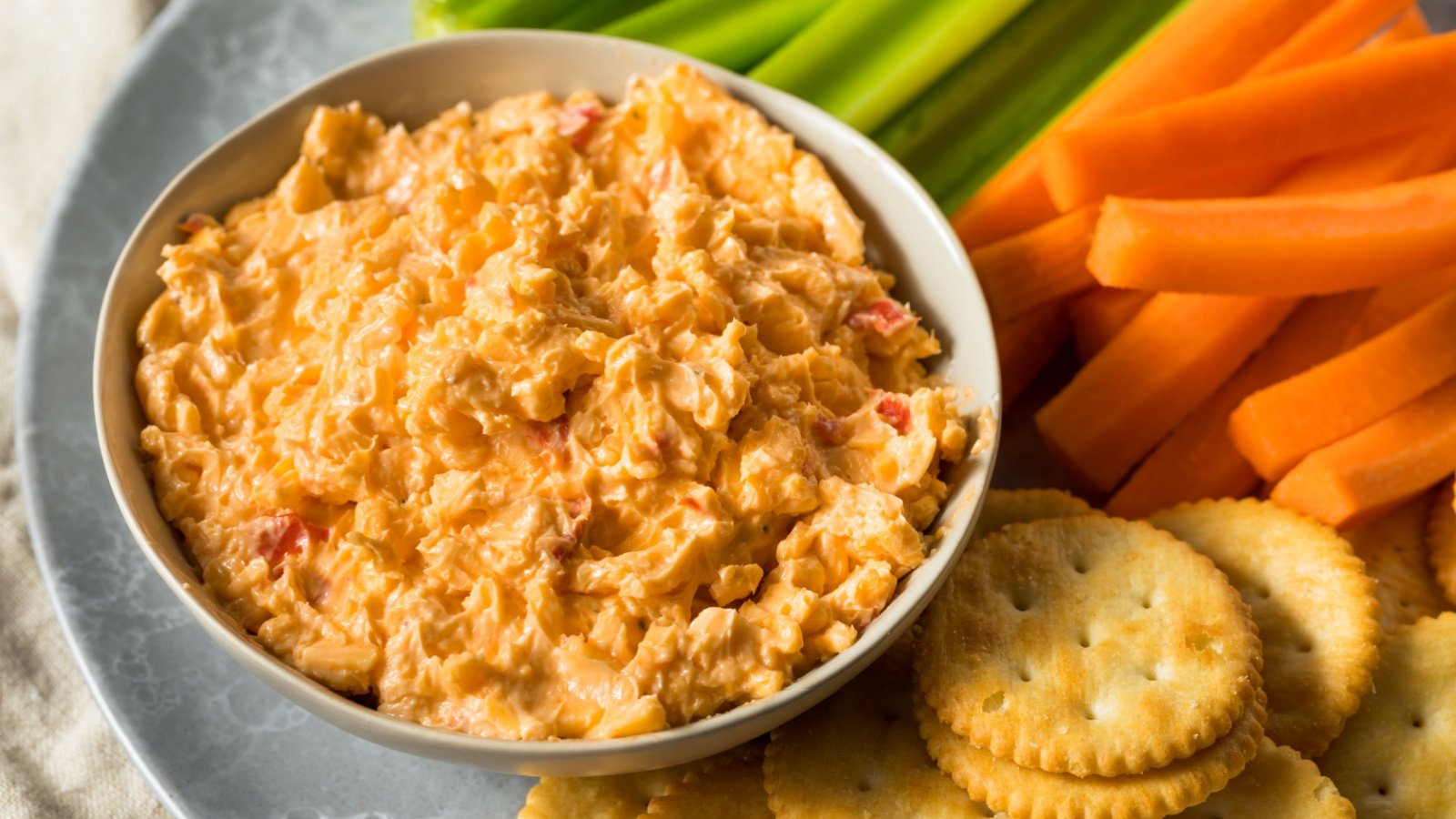 Homemade Pimento Cheese Spread with Crackers and Vegetables holiday dip potluck side dish Brent Hofacker Shutterstock Homemade Pimento Cheese Spread with Crackers and Vegetables holiday dip potluck side dish Brent Hofacker Shutterstock