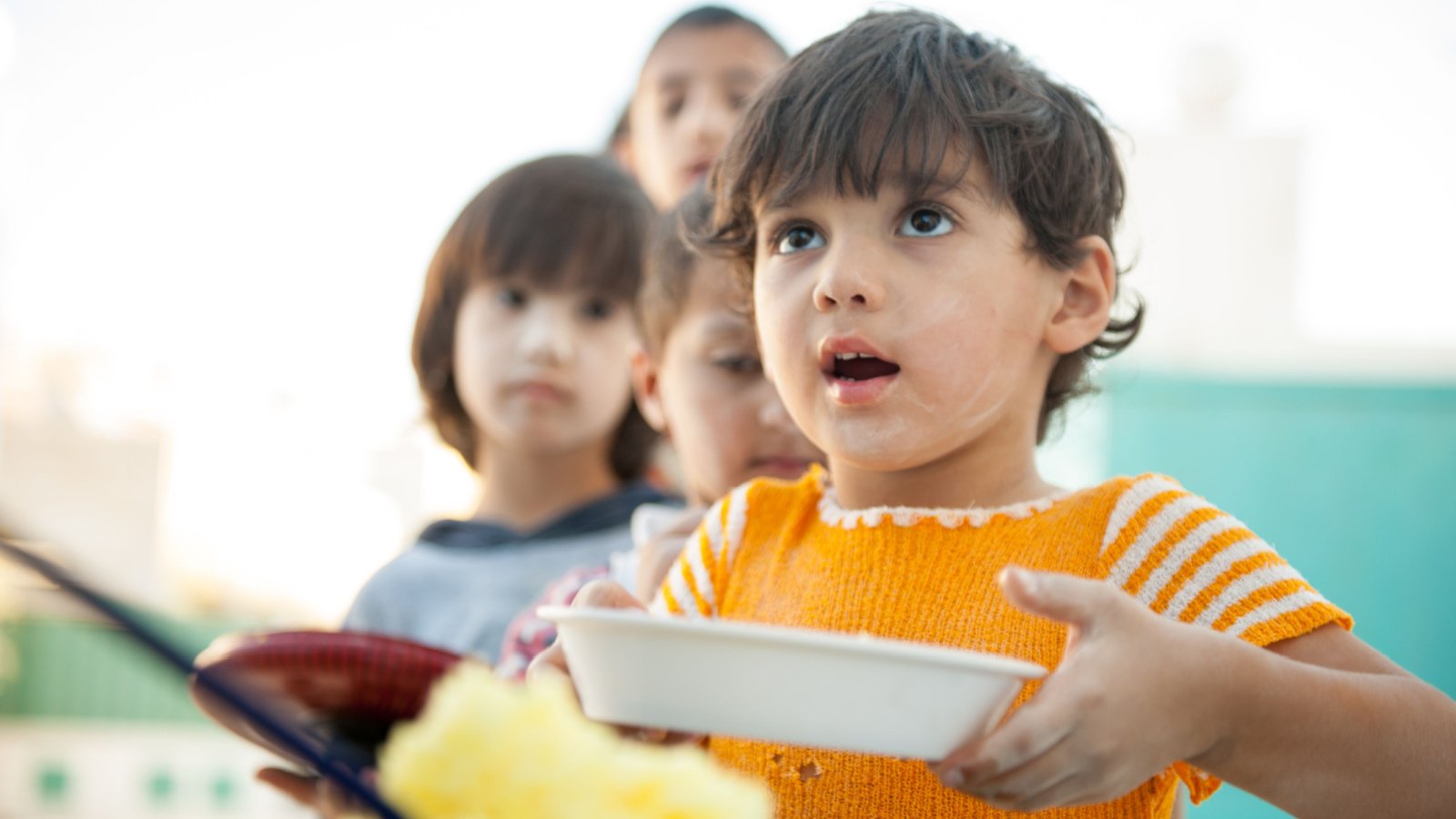 Hungry children being fed by charity poor starving Zurijeta shutterstock