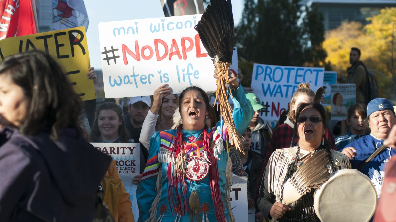 Indigenous community members walking while chanting slogans during a solidarity rally with the Dakota Access Pipeline protesters standing rock arindambanerjee shutterstock