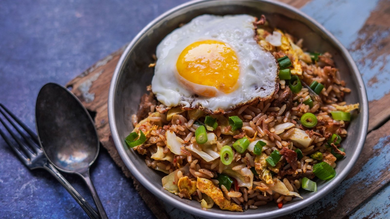 Indonesian food with rice stir fried with vegetables with fried egg Nasi Goreng Aris Setya Shutterstock