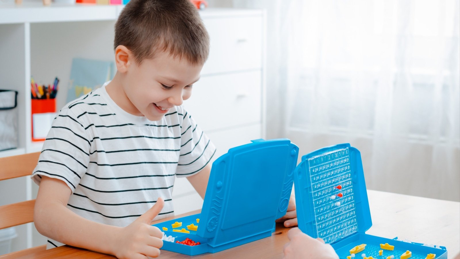 Kid Boy Battleship Game Play Juliya Shangarey Shutterstock