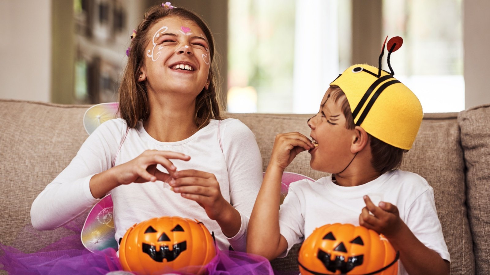 Kids children eating Halloween candy in costumes trick or treat PeopleImagescom Yuri A Shutterstock