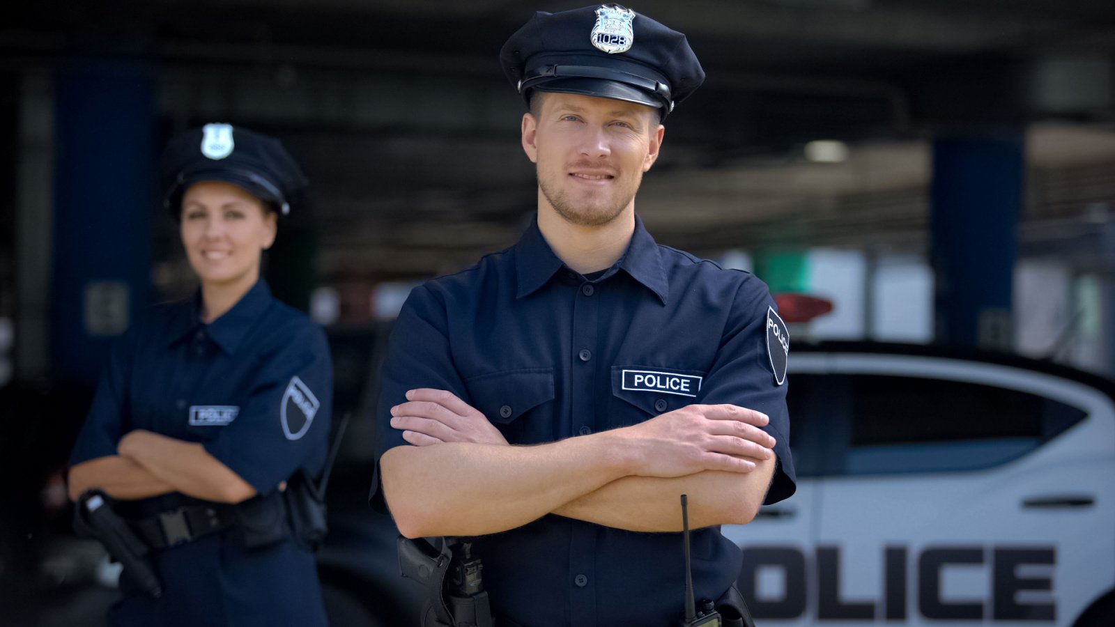 Kind police officers smiling standing near police station motortion films shutterstock