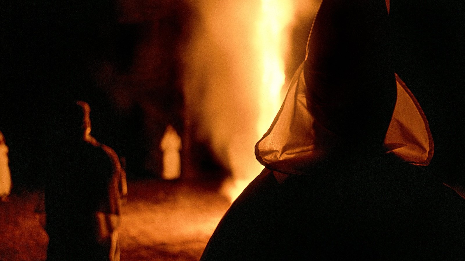 Ku Klux Klan KKK Night Rally men Wearing White Robes hoods Burning Cross Jon Rehg Shutterstock Ku Klux Klan KKK Night Rally men Wearing White Robes hoods Burning Cross Jon Rehg Shutterstock